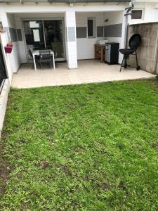 a patio with a table and a chair in a yard at jolie maison de bourg in Arvert +2 photos