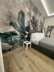 a bedroom with a bed and a wall mural at Maison Number11 in Caserta