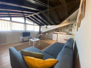 a living room with a blue couch and a table at Antik Apartments Marmaris in Marmaris