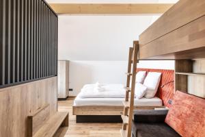 a bedroom with a bed and a bunk bed at Alpen Krone Kehlegg in Dornbirn