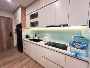 a large bottle of water sitting on the counter of a kitchen at Sam's homestay- Swan lake studio apartment in Kim Quan