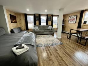 a room with a bed and a couch and a table at Berkshires Studio Apartment at the Stephentown Hotel in Hancock