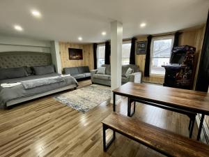 a living room with a couch and a table at Berkshires Studio Apartment at the Stephentown Hotel in Hancock