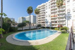 a swimming pool in front of a apartment building at AG Salinas 9 in Playa de Gandia