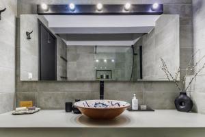 a bathroom with a sink and a large mirror at Casa Naturale in Skopelos Town +39 photos
