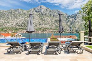 a villa with a view of the mountains at Dekaderon Lux Apartments in Kotor