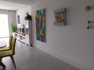 a living room with two paintings on the wall at SOTOGRANDE Hoyo 10 in Sotogrande