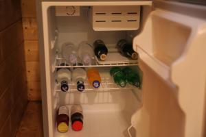 a refrigerator filled with lots of wine bottles at NICE HOUSE HOTEL Meghri in Meghri