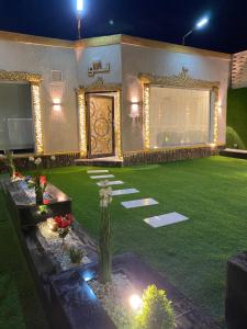 a garden at night with lights and a lawn at شاليهات لانا لاند نموذج 1 in As Sayl aş Şaghīr
