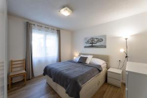 Postel nebo postele na pokoji v ubytování Apartments Bilopavlović