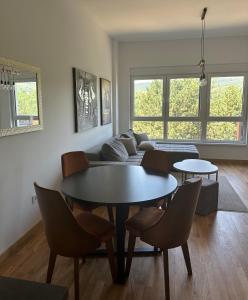 a living room with a table and chairs and a couch at Apartman 103 in Vrdnik