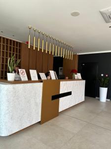 a lobby with a counter with signs on it at Apartman 103 in Vrdnik