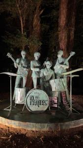 a statue of the beatles playing music at Femyli rooms in Shekvetili