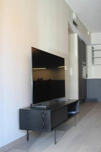 a black entertainment center with a large flat screen tv at Moderne 3 Roms leilighet i Oslobukta! in Oslo