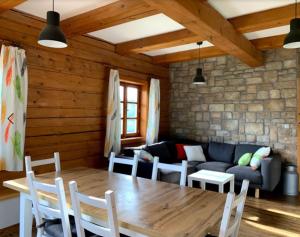 a living room with a wooden table and a couch at U Rozlitýho mlíka in Chvaleč