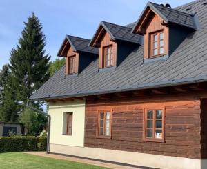 a metal roof on a house with windows at U Rozlitýho mlíka in Chvaleč