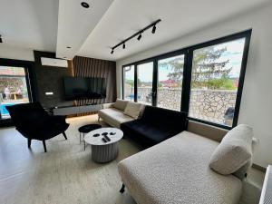 a living room with a couch and a tv at Villa Coco in Sarajevo