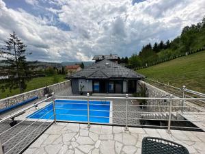 a house with a swimming pool on a roof at Villa Coco in Sarajevo