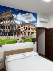 a bed in a room with the coliseum at Laura luxury apartment in the center Rome in Rome