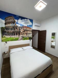a bedroom with a bed with a painting of the coliseum at Laura luxury apartment in the center Rome in Rome