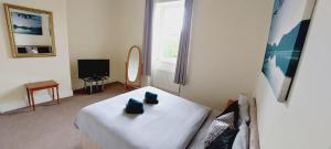 a bedroom with a bed and a window and a mirror at Eden house in Appleby