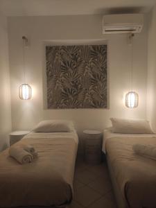 2 camas en una habitación con 2 luces en la pared en Palermo Central Apartments, en Palermo