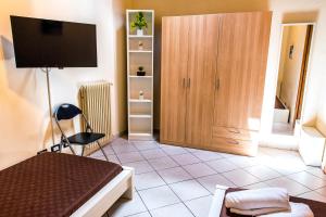パレルモにあるPalermo Central Apartmentsのベッド、テレビ、キャビネットが備わる客室です。