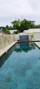 a swimming pool with blue water in a house at Villa Mary Guest House in Saint-André