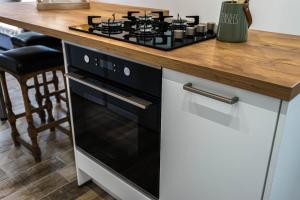 a kitchen with a black stove top oven next to a counter at La busco loge in Chinon