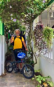a man is standing next to a bike at Reds Residency - Homestay in Cochin