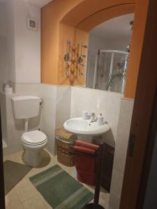a bathroom with a toilet and a sink at CASA MIKY in Palermo