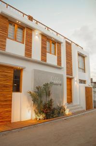 a white building with wooden shutters on it at Sabbia By LD in El Roque +17 photos