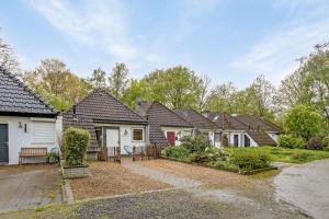 a row of houses in a residential neighborhood at Luxe Bos bungalow met Airco in Posterholt