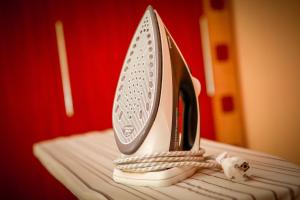a white shoe sitting on top of a bed at Babylon Apartments On Soborna in Rivne