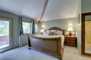 a bedroom with a large bed and a window at Vail Treehouse and Hot Tub, Sauna and Mtn Views in Vail