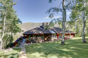 a home in the mountains with a grass yard at Vail Treehouse and Hot Tub, Sauna and Mtn Views in Vail