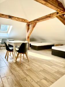 a room with two beds and a table and chairs at Zielona Mila in Sępólno Krajeńskie