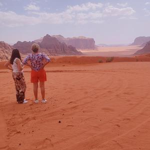 a man and a woman standing in the desert at Waid Rum Jordan Jordan in Wadi Rum