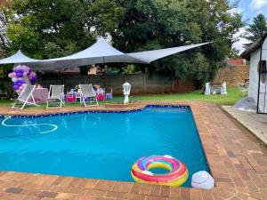 a swimming pool with a float in the middle at Horizon Garden Party & Events Venue in Randfontein