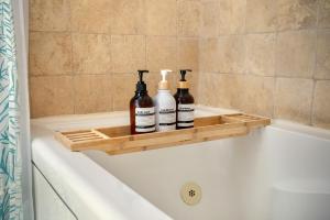 three bottles of wine sitting on the side of a bath tub at Boho Chalet in Vail on Free Bus Route in Vail +23 photos
