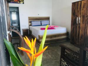 a bedroom with a bed and a plant in the foreground at fantasea villa in Unawatuna