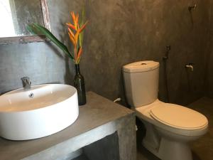 a bathroom with a white sink and a toilet at fantasea villa in Unawatuna