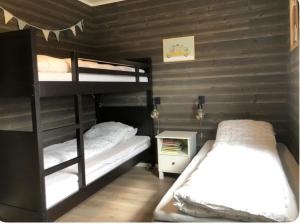 a bedroom with two bunk beds in a room at Cabin - Målselv fjellandsby in Bergset