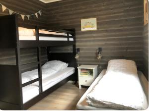 a bedroom with two bunk beds in a room at Cabin - Målselv fjellandsby in Bergset