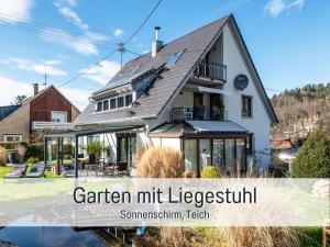 a house with the words garden mirtlezkrit at Ferienwohnung Auszeit Dachstudio in Sulzburg