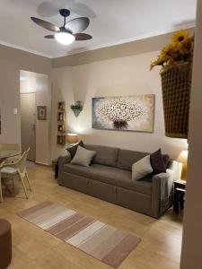 a living room with a couch and a ceiling fan at BeM Ipanema in Rio de Janeiro