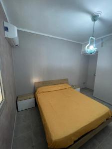 een kleine slaapkamer met een bed en een licht bij Villa Pappafico in Triscina
