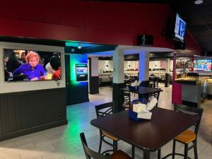 a restaurant with a table and chairs and a tv at Quality Inn St Paul-Minneapolis-Midway in Saint Paul