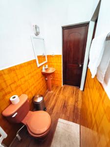 a bathroom with a toilet and a sink at Casa Sunset in Flores