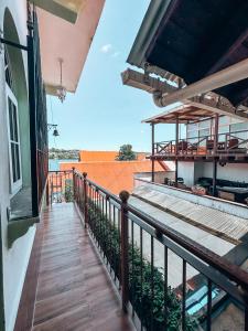 a balcony of a building with a wooden walkway at Casa Sunset in Flores